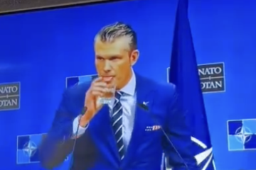 Pete Hegseth Drinking at Podium